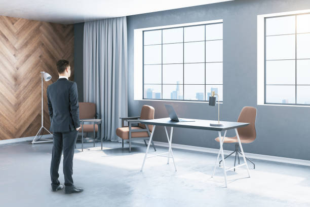 istock Businessman standing in workspace with laptop 1223835577