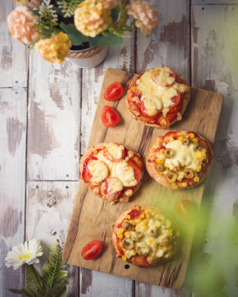 istock Mini pizza on wooden board. Top view from above 1223835697