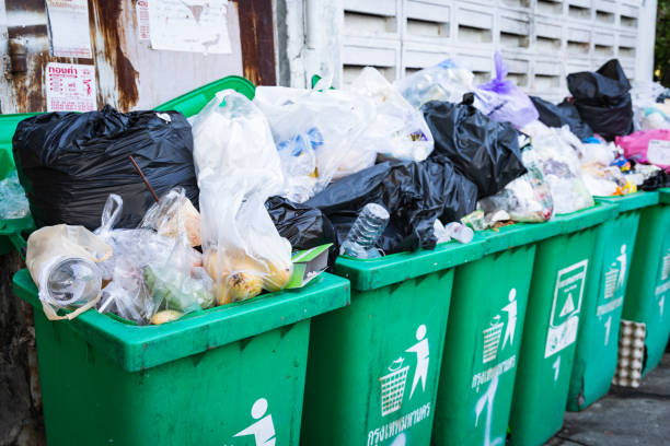Overflowing garbage bins with household waste Bangkok, Thailand, – May 3, 2020 : Overflowing garbage bins with household waste overflowing trash dumpster stock pictures, royalty-free photos & images