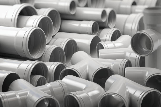 PVC plastic pipes and tubes stacked in warehouse. PVC plastic pipes and tubes stacked in warehouse. 3d illustration white plastic tube stock pictures, royalty-free photos & images