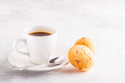 Traditional Brazilian breakfast - cheese bread and coffee, selective focus.