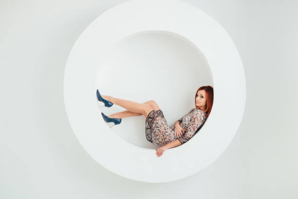 istock red-haired model girl on a white circle background 1223847257