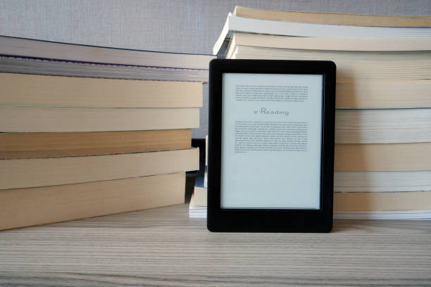 istock n e-book reader is standing in front of of the books 1223847963