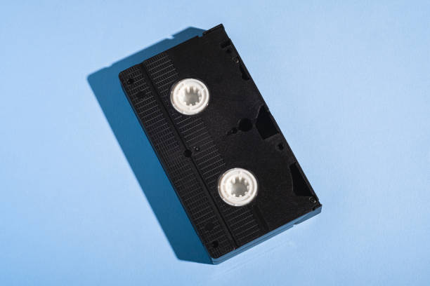 istock VHS format plastic videotape cassette, analog retro technology magnetic storage tape on minimal pastel blue background 1223851109