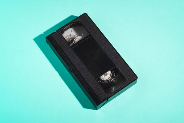 istock VHS format plastic videotape cassette, analog retro technology magnetic storage tape on minimal mint green background 1223851115