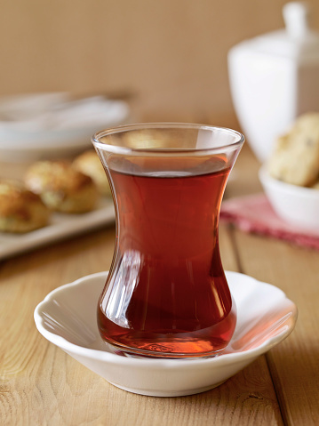 Glass of red tea in a breakfast setting on a wooden table top