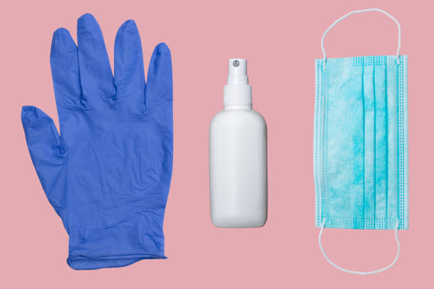 coronavirus kit with protection glove, alcohol hand sanitizer and mask on pink surface protection glove, alcohol sanitizer and mask on pink surface ambidextrous stock pictures, royalty-free photos & images