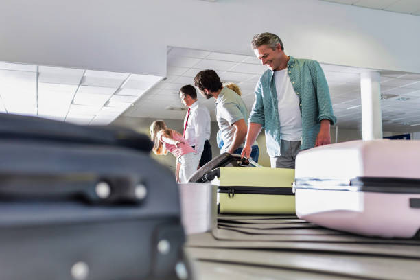 istock Man getting his suitcase on baggage claiming area in airport 1223858746