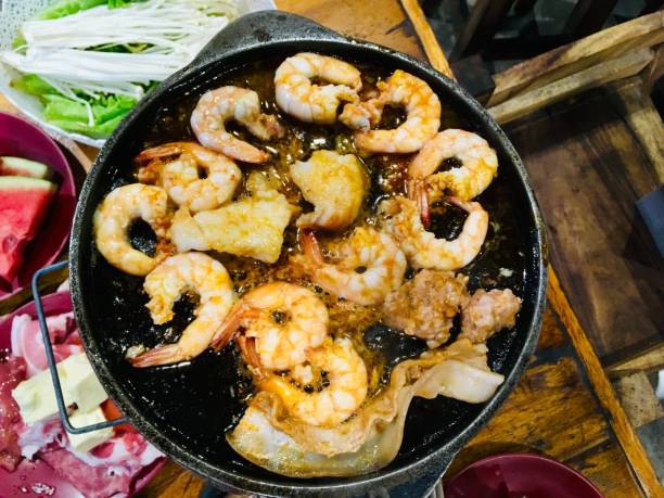 Prawns and butter grilled on a hot pan.
