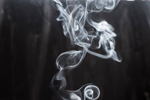 istock Image of backlit puffs of smoke, on a dark background. 1223862977