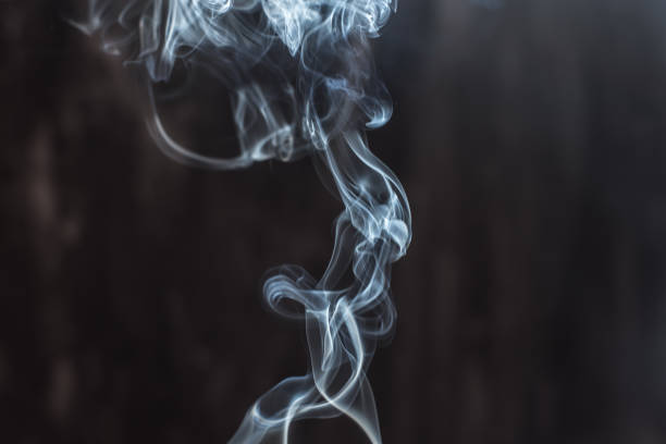 istock Image of backlit puffs of smoke, on a dark background. 1223862990