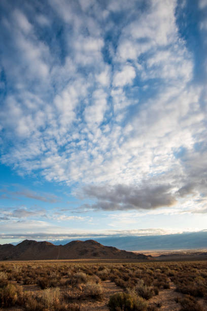 istock clouds over desert, hills and mountain landscape 1223864584