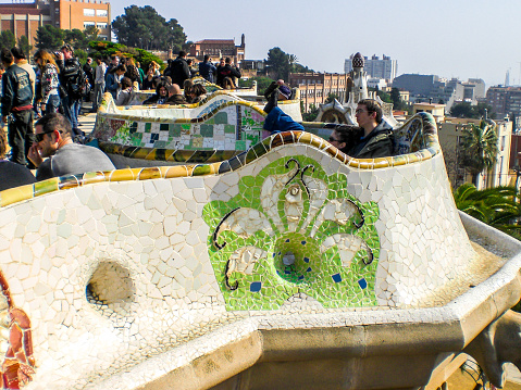 In February 2016, tourists were seating on the mosaic of Park Guell in Barcelona.