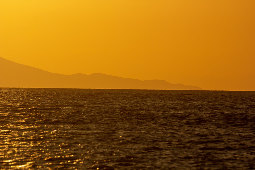 The sun sets over the Aegean Islands