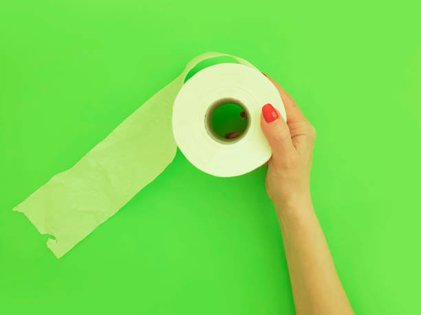 istock female hands hold toilet paper on a colored background 1223869342