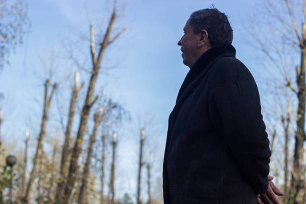 istock Senior man walking and relaxing in park 1223870883