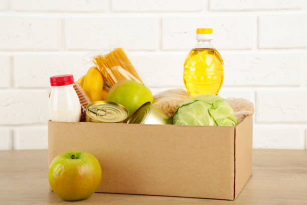 istock Donation box with food on the white brick wall background 1223870964