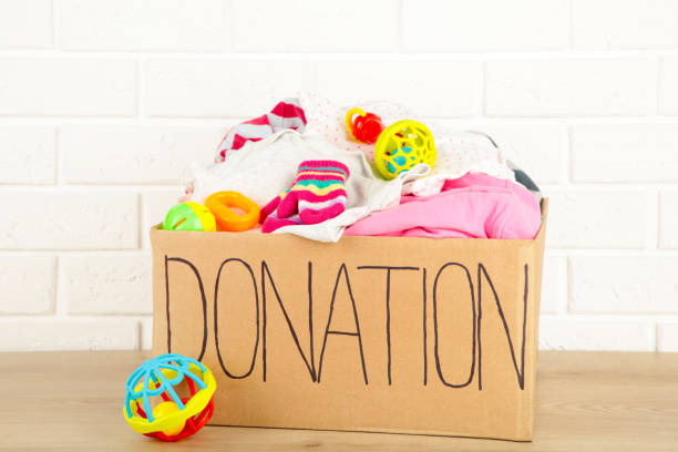 istock Donation box with baby clothes on light background 1223870977