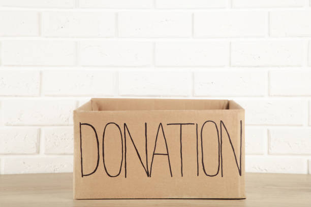 istock Empty cardboard donation box on white background. Inscription donation 1223871191