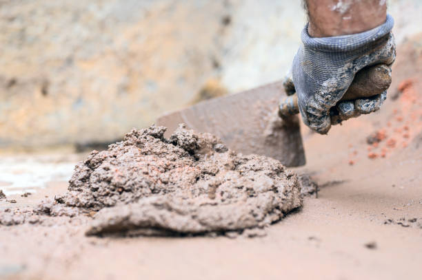 construction worker man hand using trowel to mix mortar. - plasterer construction site manual worker plaster imagens e fotografias de stock