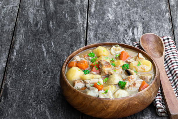 istock Stewed pork with vegetables in wooden bowl on rustic table 1223873338