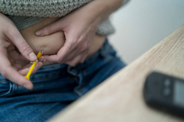 istock Woman making injection with syringe pen 1223876834