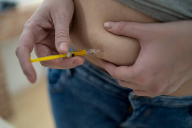 istock Woman making injection with syringe pen 1223876880