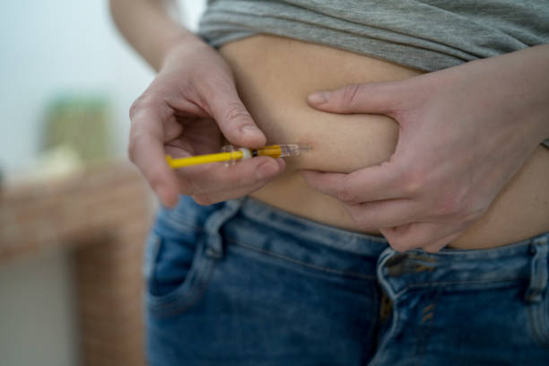 istock Woman making injection with syringe pen 1223876894