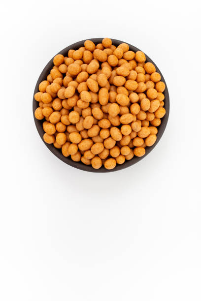 istock Peanuts in coconut glaze in round bowl on white background, top view 1223877860