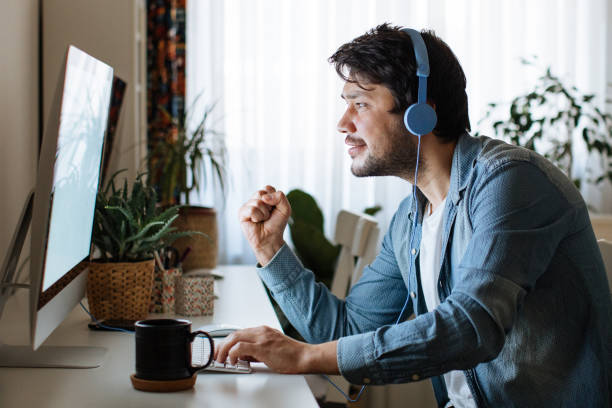 istock Young men playing video games with desktop 1223879594