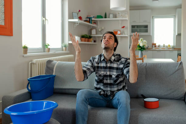 istock Water Droplets Leak From Ceiling in Living Room 1223881862