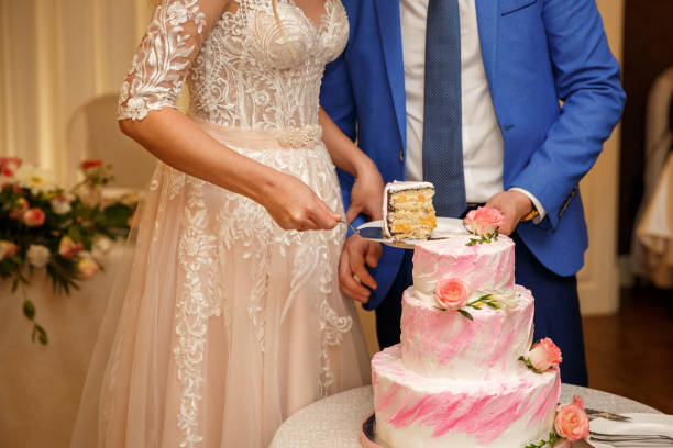 istock Bride and groom cutting wedding cake at wedding day 1223882618