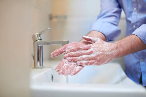 istock coronavirus male wahing hands in bathroom 1223885734