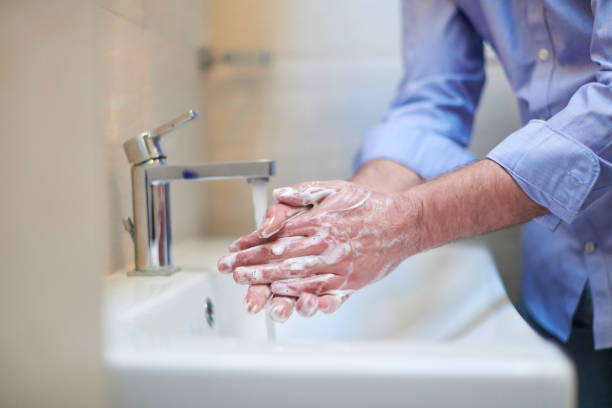 istock coronavirus male wahing hands in bathroom 1223885744