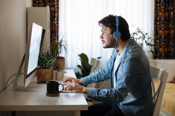istock Young men playing video games with desktop 1223886010