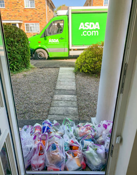 Supermarket delivery service from Asda Oxfordshire, England - April 14, 2020: Delivery man from ASDA left all food groceries outside at the front door. asda photos stock pictures, royalty-free photos & images