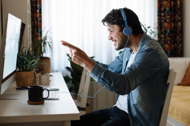 istock Young men playing video games with desktop 1223886747