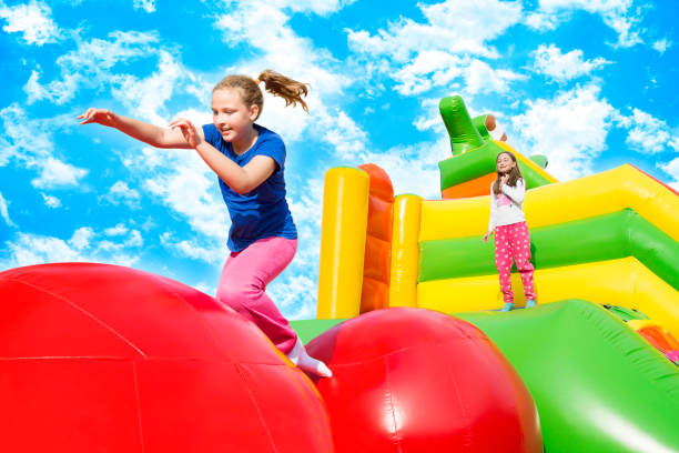 istock Happy Girls Jumping on Inflate Castle 1223886815