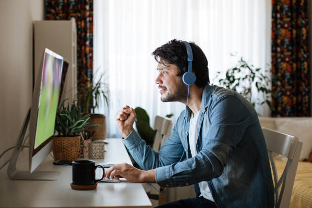istock Young men playing video games with desktop 1223887505