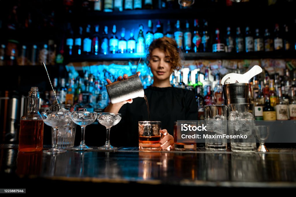 Young Lady At Bar Pours Cocktail Into Glass Stock Photo - Download Image  Now - Bartender, Women, Whiskey - iStock