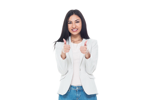 One person of aged 20-29 years old who is beautiful latin american and hispanic ethnicity young women standing in front of white background wearing jacket who is happy and showing ok sign