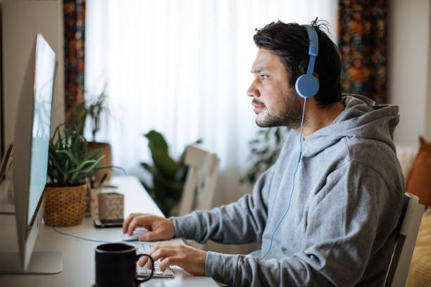 istock Young men playing video games with desktop 1223888888