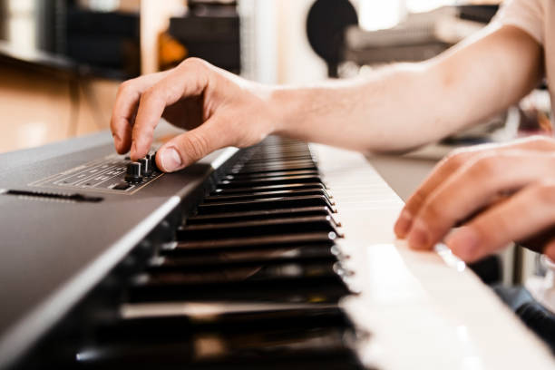 istock Young man playing electric piano in studio 1223889128