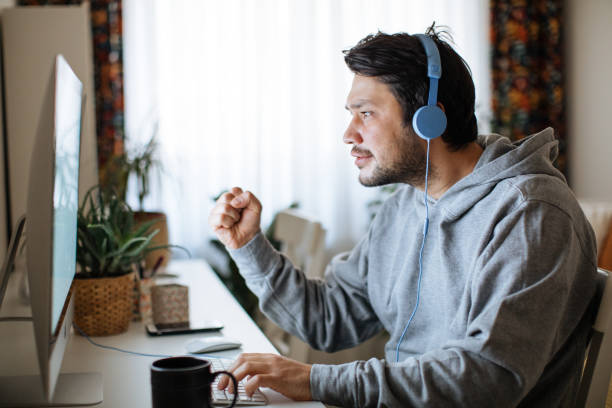 istock Young men playing video games with desktop 1223889169