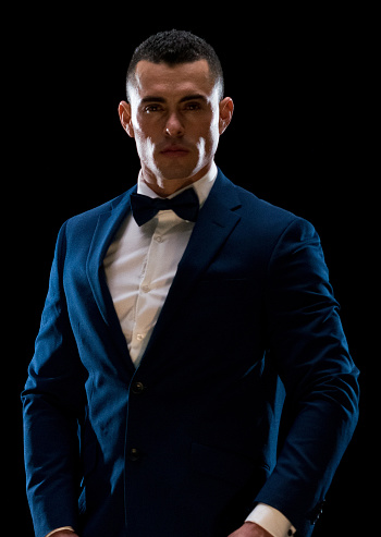 Portrait of aged 20-29 years old latin american and hispanic ethnicity young male business person in front of black background wearing businesswear who is in concentration