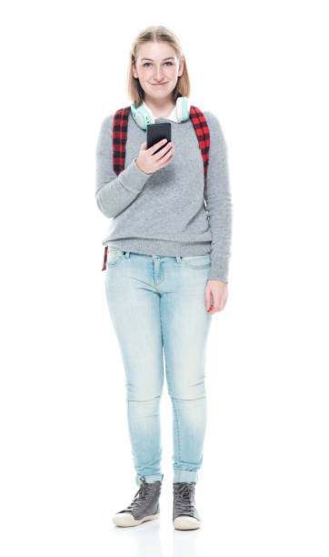 istock Generation z young women student standing in front of white background wearing backpack and holding bag and using smart phone 1223892271