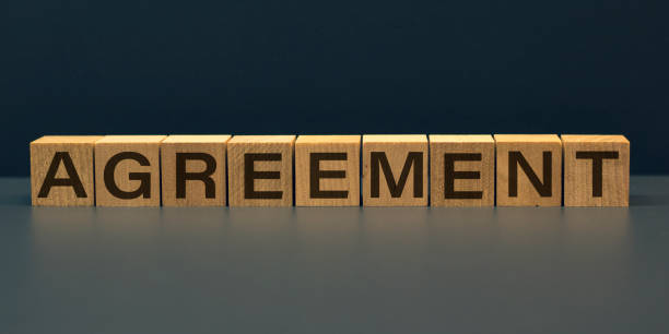 istock AGREEMENT word on wooden cubes on gray background 1223894981
