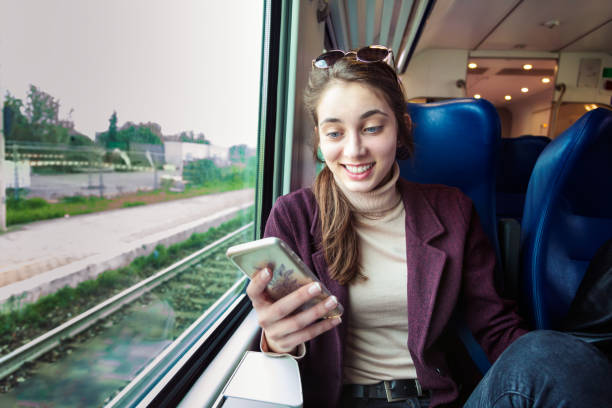 istock Young girl using smart phone in subway train 1223895658