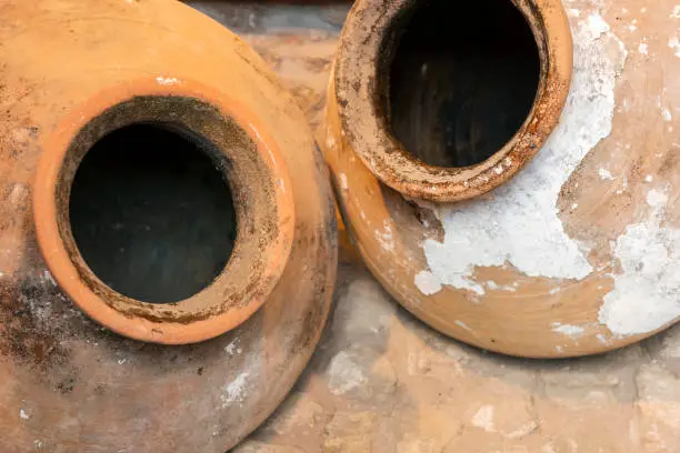 Detail of two brown old large clay amphorae in Lesbos, Greece.