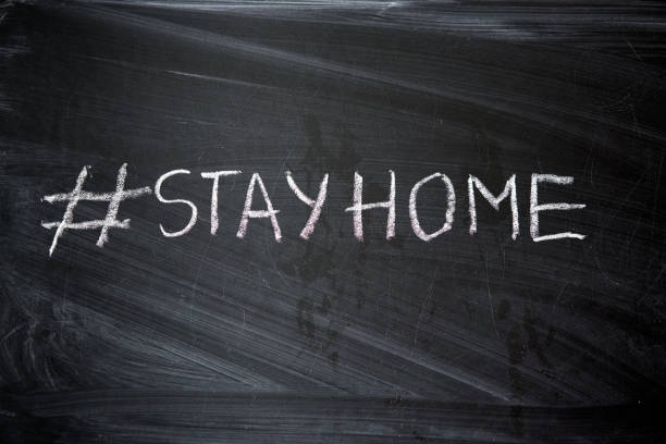 istock Hashtag stay at home. Outbreak Warning. written white chalk on blackboard in connection with epidemic of coronavirus worldwide. 1223895938